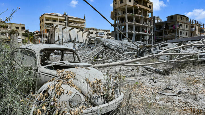 A destroyed vehicle and buildings are pictured in the town of Nabatieh al-Fawqa in southern Lebanon on June 23, 2026