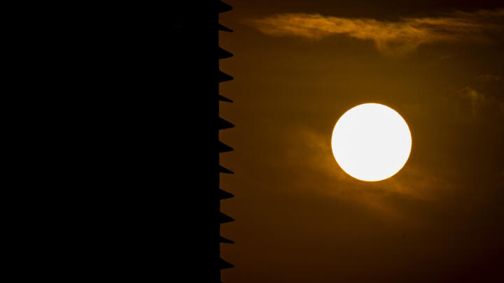 The sun is pictured next to the silhouette of a building during sunset in Panama City on April 9, 2026