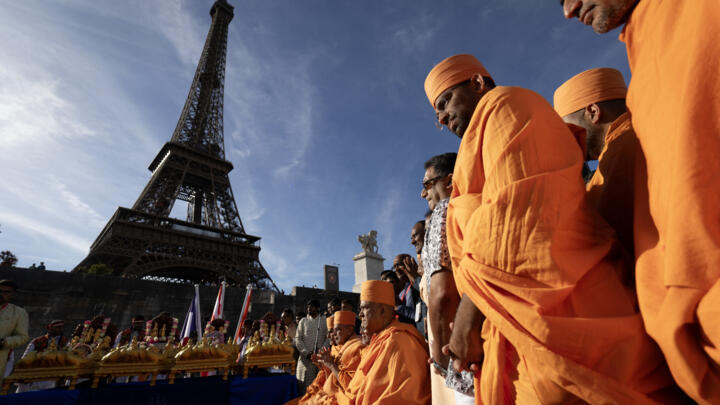 Bochasanwasi Akshar Purushottam Swaminarayan Sanstha (BAPS) Hindu monks participate in a religious ceremony in front of the Eiffel Tower on September 3, 2026.