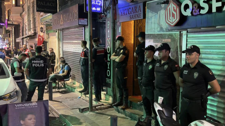 Handout photograph taken and released on September 13, 2026 by Turkish news agency DHA (Demiroren News Agency) shows Turkish police standing outside a night club during a raid in Istanbul. 