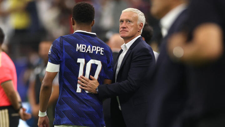 Didier Deschamps comforts France's captain Kylian Mbappé at the Dallas Stadium after losing to Spain.