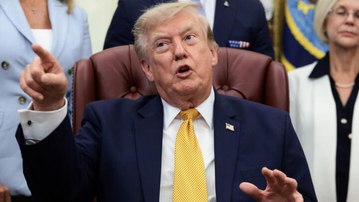 US President Donald Trump points his finger as he answers questions from the media after signing an executive order establishing the President's Military Spouse Commission 