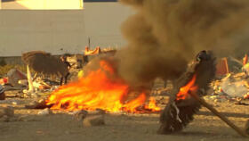 Smoke and flames rise as Ceuta residents destroy migrant camp by the beach, in Ceuta, Spain, August 27, 2026.