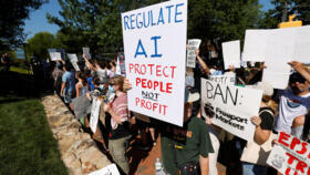 A demonstrator holds a sign calling for regulation of artificial intelligence during a protest outside the G20 Innovation Ministerial summit, in Chapel Hill, North Carolina, U.S., September 2, 2026.