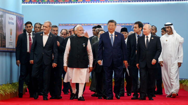 Participants, including Russia's President Vladimir Putin, China's President Xi Jinping, India's Prime Minister Narendra Modi and Iran's President Masoud Pezeshkian, walk during the BRICS summit in Ne