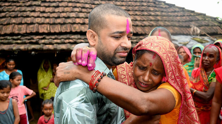 Nepali hydropower worker Sanjay Sah meets his mother at his residence in Nepal's Saptari district on September 13, 2026 after being rescued from a flooded tunnel.