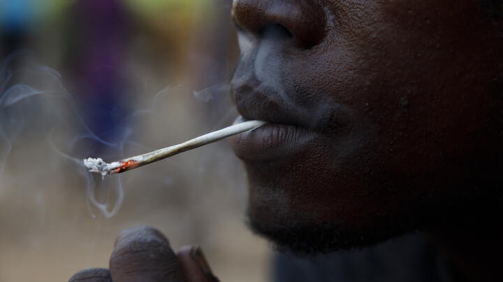 A young man smokes Kush, a derivative of cannabis mixed with synthetic drugs like fentanyl and tramadol and chemicals like formaldehyde, at a hideout in Freetown, Sierra Leone, April 29, 2024.