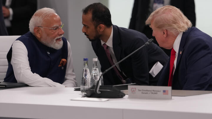 Indian Prime Minister Narenda Modi talks to US President Donald Trump before the plenary session at the G7 summit, June 16, 2026, in Evian-les-Bains, France