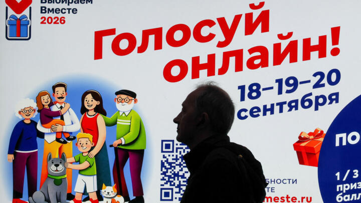 A man walks past a screen announcing Russia's upcoming parliamentary election and promoting online voting, in Moscow, Russia, September 7, 2026