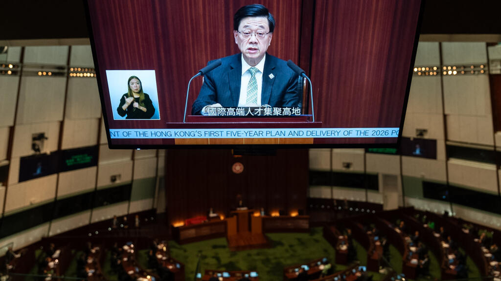 A television monitor shows Hong Kong's Chief Executive John Lee delivering the first Five-Year Plan and policy address at the Legislative Council in Hong Kong, September 16, 2026