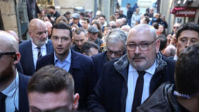 President of the far-right RN party Jordan Bardella walks next to RN mayor of Carcassonne Christophe Barthes on February 7, 2026.