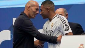 File photo: Former French player Zinedine Zidane, left, embraces French forward Kylian Mbappé on his presentation to fans as a new Real Madrid player, Madrid, July 16, 2024