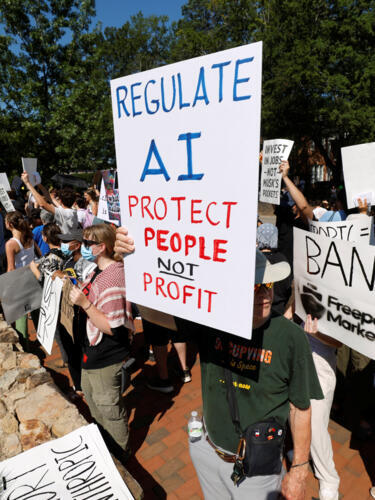 A demonstrator holds a sign calling for regulation of artificial intelligence during a protest outside the G20 Innovation Ministerial summit, in Chapel Hill, North Carolina, U.S., September 2, 2026.