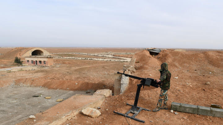 (FILES) A member of Syrian government forces, stands guard the Abu Duhur military air base area in Idlib province, on January 21, 2018.