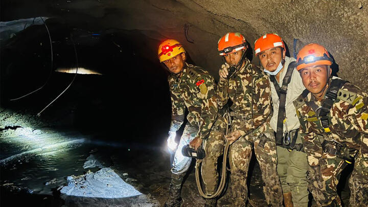 Nepali soldiers inspecting a tunnel to rescue workers after flash floods at Rasuwagadhi Hydropower Project in Rasuwa district