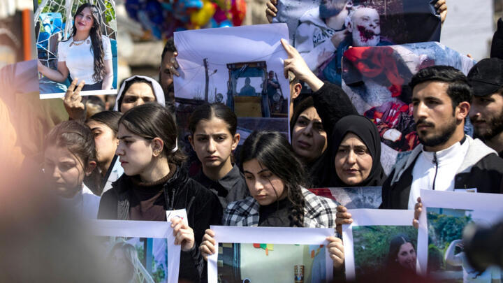 People in Syria's northeastern city of Qamishli on March 11, 2025 protest against a recent wave of sectarian violence targeting Syria's Alawite minority.