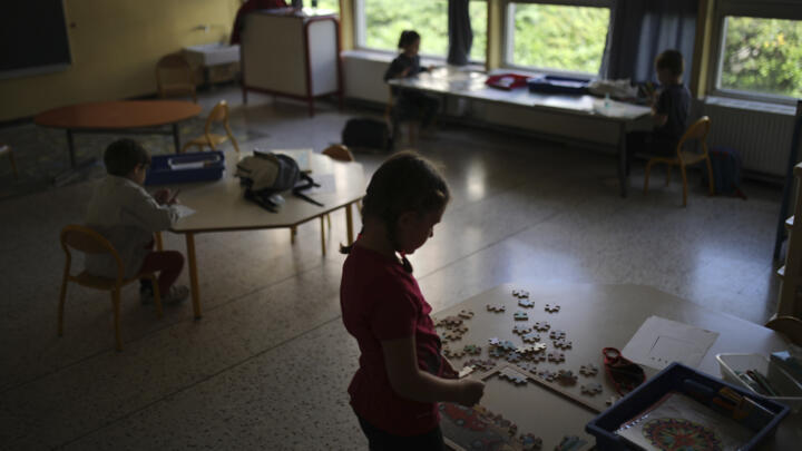 This file photo shows children playing with jigsaw puzzles in a primary school classroom in Marseille on May 14, 2020